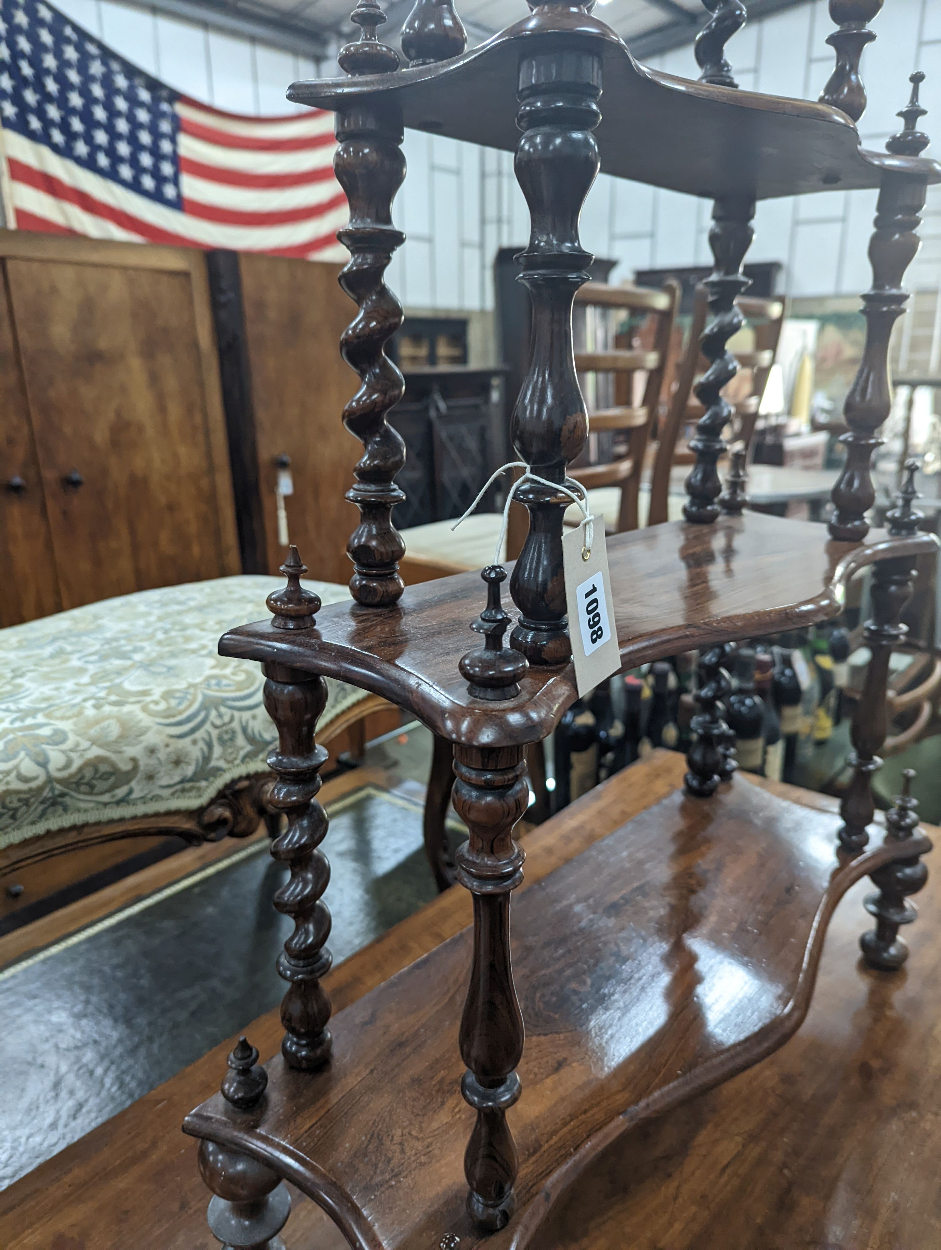 A small Victorian rosewood serpentine fronted four tier whatnot, width 61cm, depth 21cm, height 94cm